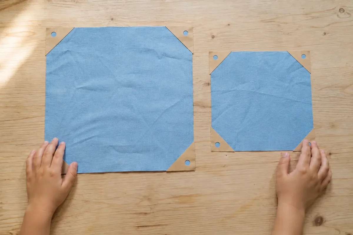 Étape 2 — renforcer les huit coins pour parachute en tissu : comparer deux tailles de voile, avec huit coins renforcés et perforés à distance égale du bord